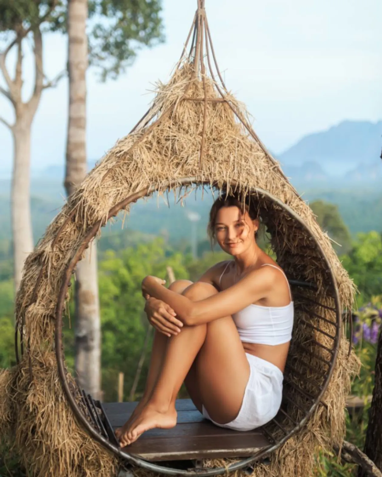 Female traveler In straw swing chair Sri Lanka